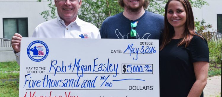 Coalition President David Walker presents the Easley's with a check